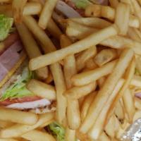 Club Sandwich & French Fries · Club sandwich, with a side of french fries.