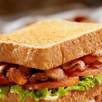 Club Sandwich · Bread, mayo, lettuce, tomato, turkey, ham and bacon with fries.