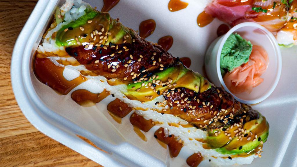 Dragon Roll · Shrimp tempura and crab salad cucumber topped with avocado,  unagi and teriyaki sauce