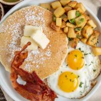 American Breakfast · Two eggs, two mini pancakes, bacon, choose of breakfast potatoes or fruit.