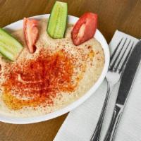 Hummus · Most popular. Tahini sauce, garlic, lemon juice, garbanzo beans blended and topped with oliv...