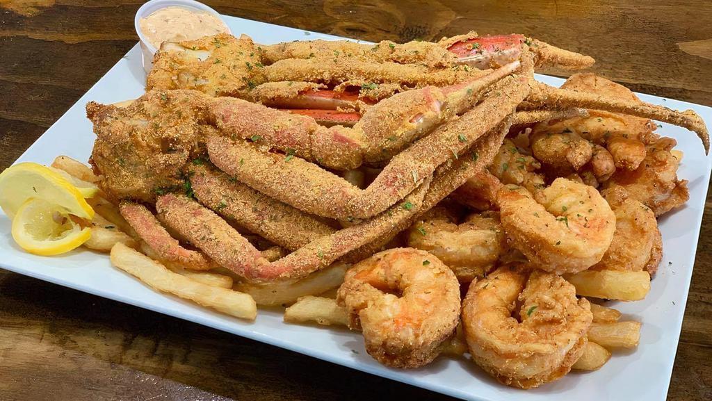 Fried Crab With Shrimp & Chips · Succulent Fried Crab and golden fried Shrimp served on a bed of fries w/ buttered garlic roll.