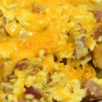 Country Skillet · Two diced sausages and two strips of bacon scrambled with two eggs, topped with cheddar chee...