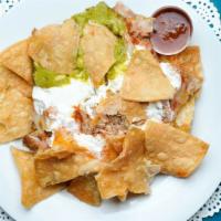 Nachos With Carnitas · Homemade corn chips, covered with our special sauce, Jack and Cheddar cheese, topped with gu...