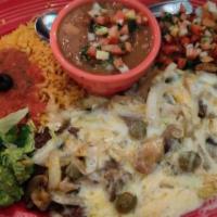 Carne Ranchera · Large thin mexican style steak, topped with sauteed mushrooms, guacamole, pico de gallo and ...