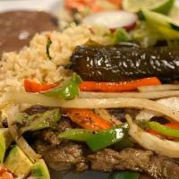 Higado Encebollado · Liver and onions rice beans salad and tortillas.