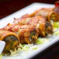 Bacon Jalapeño Poppers · Five fresh jalapeños wrapped in bacon, stuffed with Jack, mozzarella, and cream cheeses. Ser...