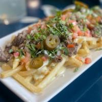 Carne Asada Fries · Crispy fries layered with steak and Cicada cheese dip. Topped with tomato, cilantro, onion, ...