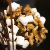 Rocky Road Caramel Apple · A Granny Smith apple covered in fresh caramel then rolled in a mixture of walnuts and marshm...