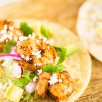 Grilled Shrimp Taco · Hearty prawns, cabbage, pico de gallo, and sour cream folded into a warm tortilla.