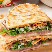 Reggio Sandwich · Prosciutto, parmigiano-reggiano, mozzarella, mushrooms, arugula, tomatoes, tartar sauce, and...