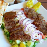 Greek Gyros Salad · Greek salad topped with eight ounces of gyros.