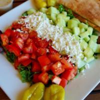 Greek Salad · Green salad topped with feta cheese, olives, and peperoncini with house dressing on the side...