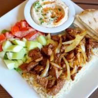 Shish Kebab Plate · Tender pieces of marinated lamb with grilled onions; served with hummus, pita bread, salad, ...