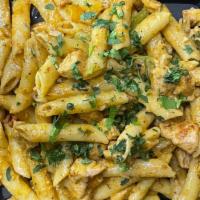 Cajun Chicken Pasta · Penne pasta, Cajun chicken and bell peppers  tossed in our Cajun cream sauce, topped with ci...
