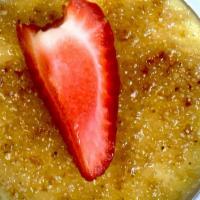 Creme Brulee · Topped with caramelized brown sugar and strawberries.