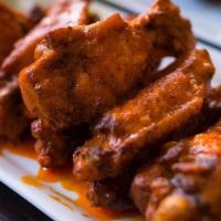 Tapatio Wings · Eight wings sauté in Tapatio and búfalo sauce with fries.