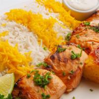 Salmon · Fresh filet of salmon marinated and charbroiled, served with Salad and Fava bean and Dill rice