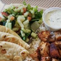 Chicken Platter · Gyro chicken platter served with seasoned basmati rice, salad, warm pita tzatziki, and chutn...