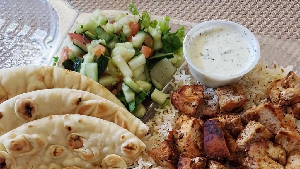 Chicken Platter · Gyro chicken platter served with seasoned basmati rice, salad, warm pita tzatziki, and chutney sauces.