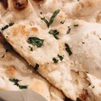 Naan Bread · Baked bread in a clay oven. Add garlic, onion or cheese for an additional charge. Vegetarian.
