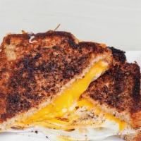 Grown Up Grilled Cheese · Refined palettes only need apply. Melty cheddar, mozzarella, and jack cheeses between two sl...