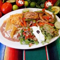 Fajitas · Your choice of Steak, Chicken, or Shrimp fajitas with a salad, rice, beans and tortillas.