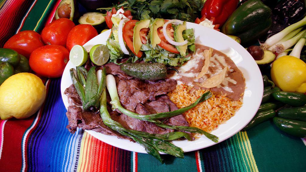 Carne Asada (Combo) · Thinly sliced steak, with a side of rice, beans, salad and tortillas.