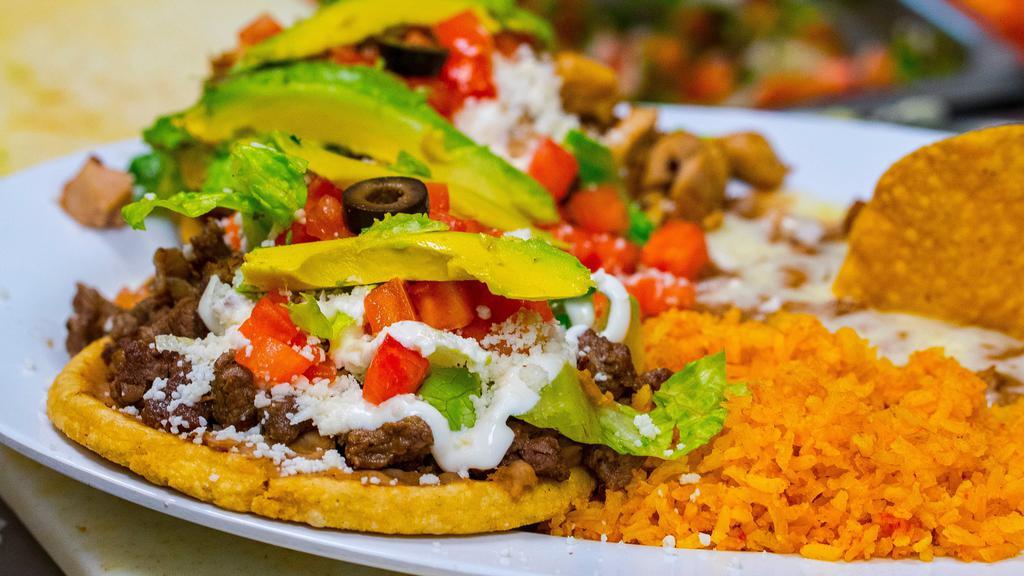 Sopes (2) · Two Crispy classic sopes topped with your choice of protein, beans, lettuce, avocado, tomatoes, olives, sour cream and queso fresco. Served with rice and beans