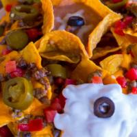 Super Nachos · Chips with your choice of meat, cheese, beans, sour cream, guacamole,  jalapeños, olives, an...