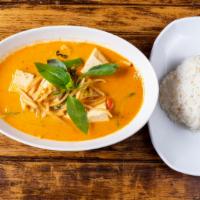 Red Curry /W Rice · Red curry paste cooked with your choice of meat, bamboo shoots, bell peppers, basil and coco...