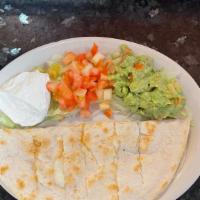Quesadilla Appetizer · A flour tortilla filled with melted Monterey jack cheese with a side of sour cream, diced to...