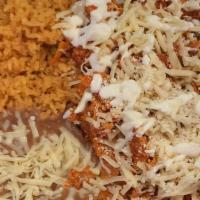 Chilaquiles · Corn tortillas mixed with scrambled eggs and onions, in a spicy sauce topped with cotija che...