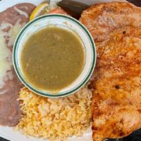 Chicken Breast A La Plancha · Marinated chicken breast grilled and served with green sauce and rice and beans on the side.