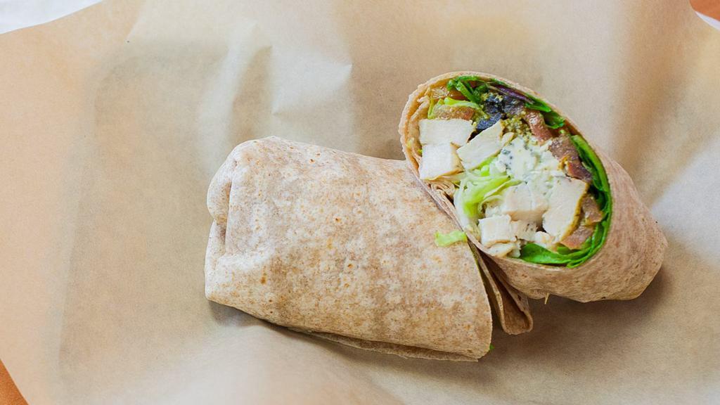 Pesto Chicken Wrap · Basil pesto sauce, chicken breast, bleu cheese crumbles, olives, tomatoes and spinach on whole wheat wrap.