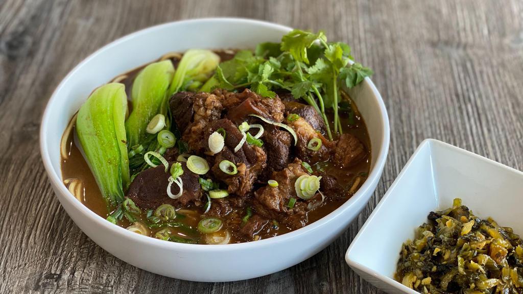 Taiwanese Beef Noodle Soup · Braised beef with green cabbage, cilantro, in our housemade spiced beef broth.