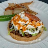 Sopes · Beans, lettuce, cheese, sour cream, tomatoes, salsa and your choice of meat.