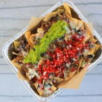 Nacho Box · Juicy carnitas, queso, housemade guacamole, pico de gallo, served on our housemade tortilla ...