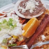 Chilaquiles · Tortilla chips tossed in green tomatillo sauce, topped with two fresh eggs, queso fresco, an...
