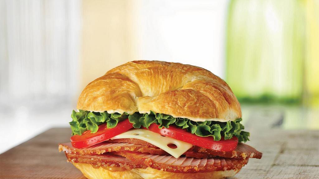 Ham Classic · Honey Baked Ham topped with Swiss cheese, lettuce, tomato, Duke’s® mayonnaise, and hickory honey mustard on a flaky croissant. 630 cal.