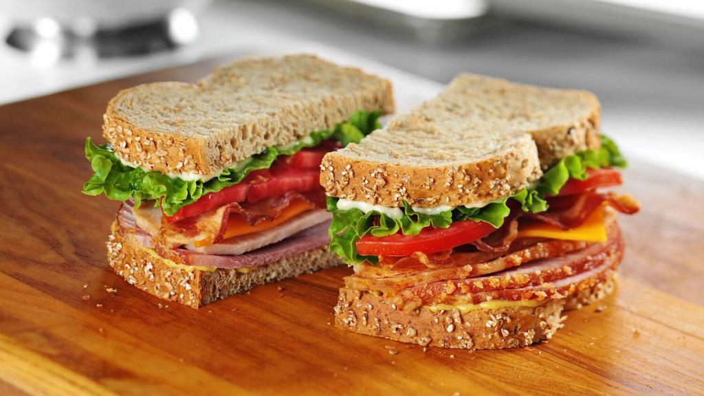 Tavern Club · Honey Baked Ham and smoked Turkey Breast piled high with bacon, cheddar cheese, lettuce, tomato, Duke’s® Mayonnaise and Dijon Honey Mustard on multigrain bread. 1010 cal.