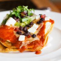 Huevos Rancheros · Fried eggs served over corn tortillas topped with warm salsa.