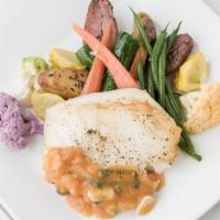 Baked Chilean Seabass Provencal · Served with petit legumes, fingerling potatoes and lemon butter tomato capers sauce