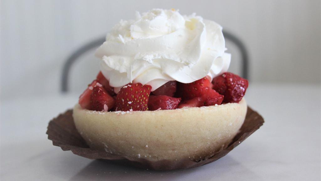 Strawberry Pizza (Seasonal) · Sugar cookie crust filled with a vanilla bean cheesecake and topped with fresh, glazed strawberries, whipped cream and white chocolate shavings.