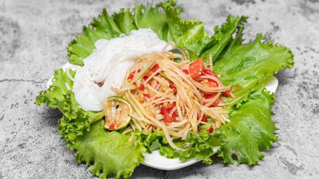 Papaya Salad · Vermicelli noodles and iceberg lettuce included. Pounded in Thai chili, garlic, tomatoes, fish sauce, fermented fish, or salt with lime juice using traditional mortar and pestle.