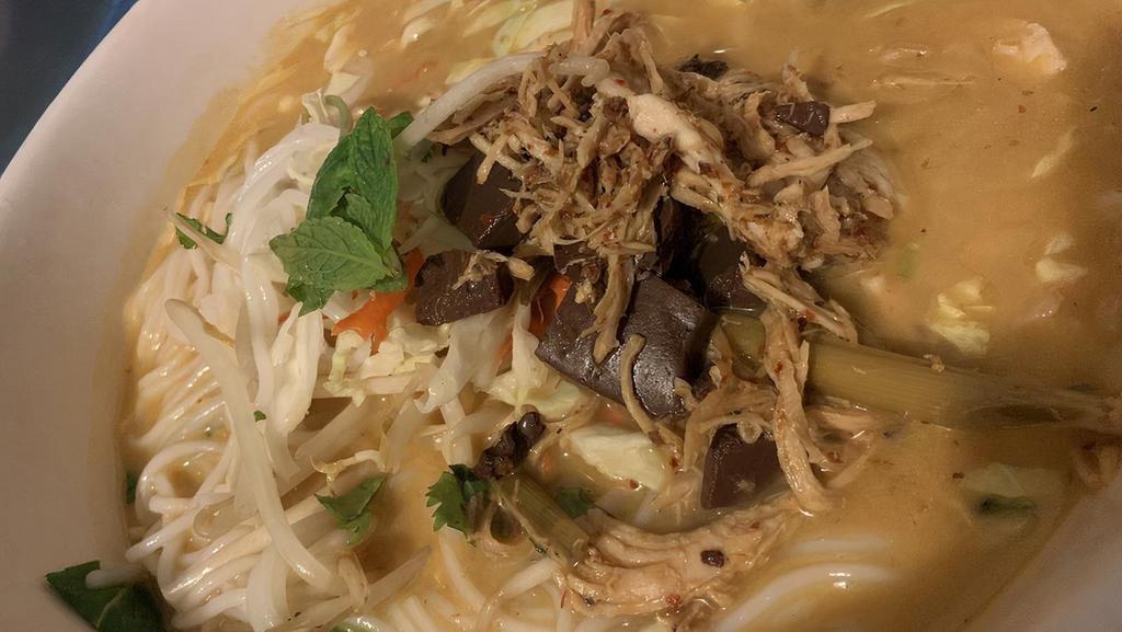 Khao Poon Noodles · Large size only. Vermicelli noodles, chicken broth sautéed in coconut milk, red curry paste, kaffir lime leaves, ginger, galangal, and pork blood cubes, served with bean sprouts and shredded cabbages.