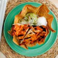 Grilled Chicken Tostada · Grilled achiote basted chicken breast above layers of refried beans, lettuce, cheese, diced ...