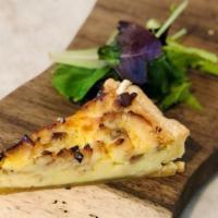 Quiche Lorraine · Bacon, Swiss Cheese and Onion served with a side Mixed Green Salad
