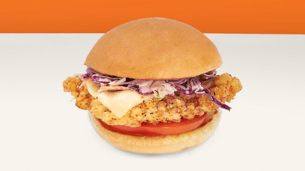 Deluxe Chicken Sandwich · Fried chicken sandwich with cheese, tomato, coleslaw, and mayo on a potato roll.