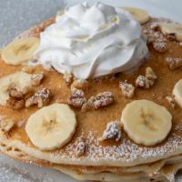 Banana Pancakes · Topped with powdered sugar and whipped cream.